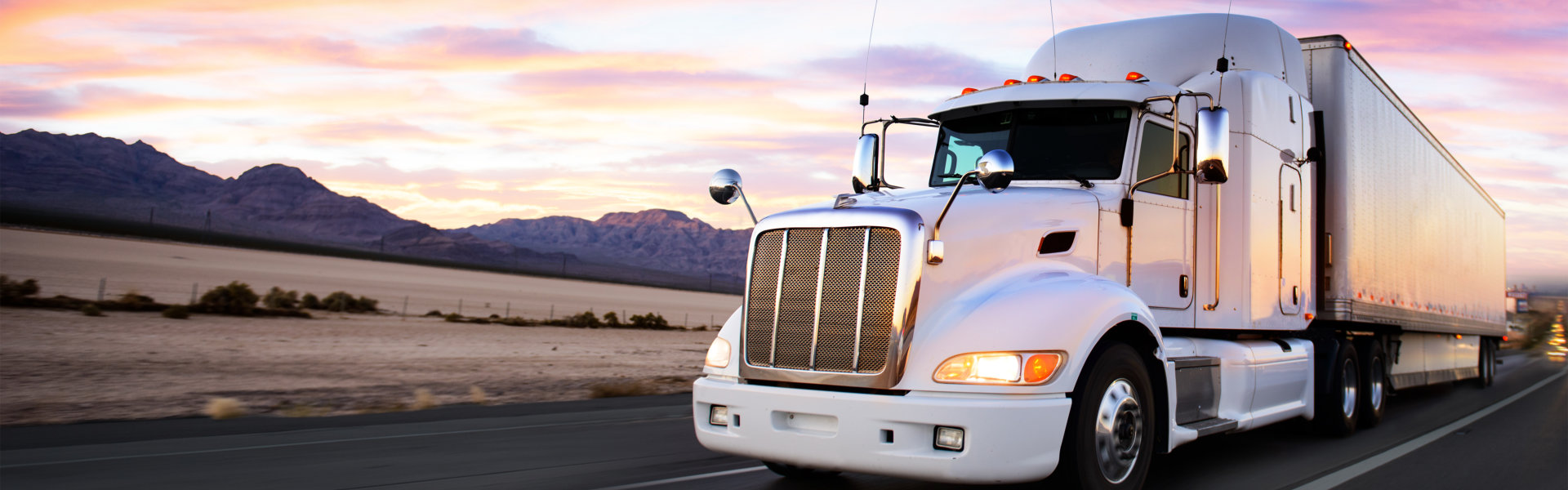 Truck and highway at sunset